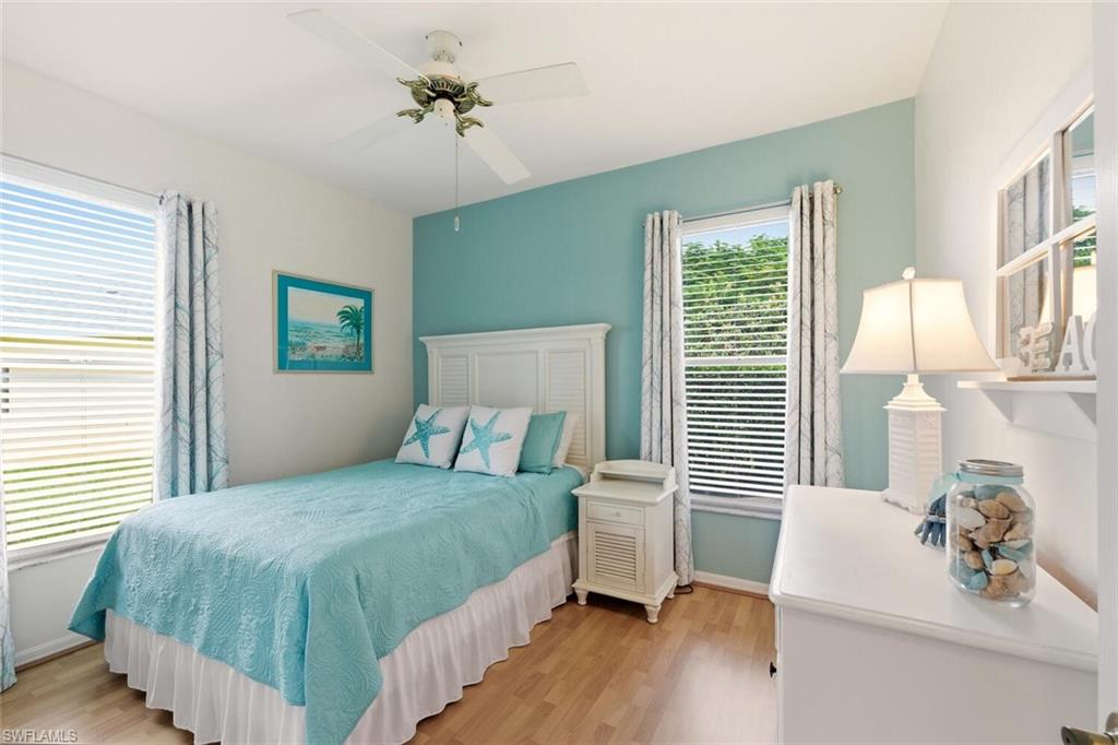 157 Versailles Circle Naples, FL 34112 - Photo 20 of 36 a bedroom with a bed and a table chair