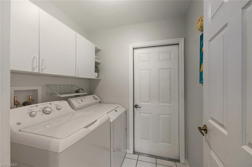 157 Versailles Circle Naples, FL 34112 - Photo 24 of 36 a utility room with dryer and washer
