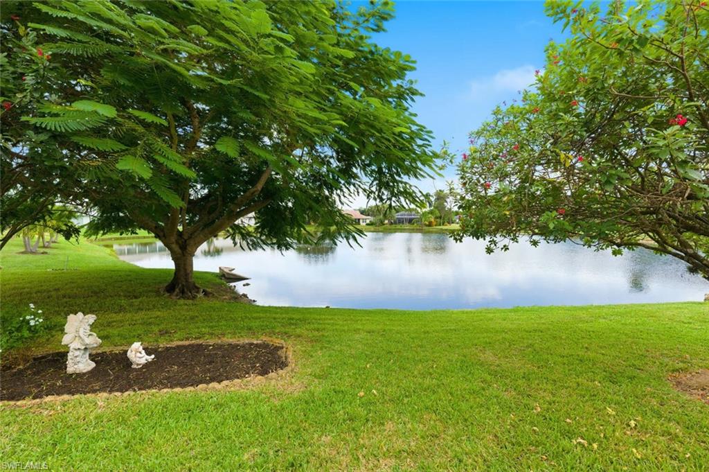 157 Versailles Circle Naples, FL 34112 - Photo 27 of 36 a view of a lake from a garden