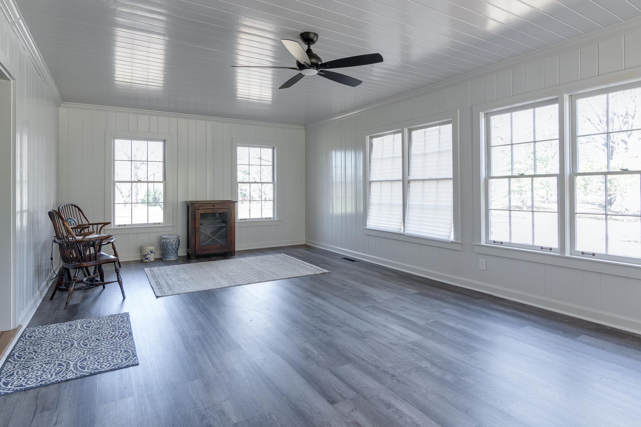 506 Peterson Lake Road Collierville, TN 38017 - Photo 15 of 28 wooden floor in an empty room with a window and a kitchen