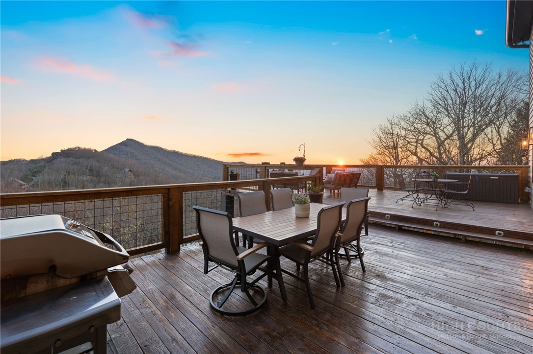 351 Windy Knob Trail Seven Devils, NC 28604 - Photo 15 of 50 a view of a chairs and table on the deck