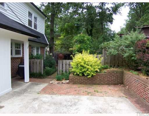 519 Gardner Street Raleigh, NC 27607 - Photo 10 of 12 Two car parking pad next to back porch. Enter iron gate to back yard paradise with gazebo, hot tub, flower garden and blueberry bushes. Parking Lot/Garage
