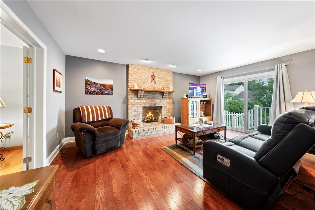 4568 Greenfield Road Bethlehem, PA 18017 - Photo 11 of 59 Warm hardwood floors and a brick fireplace create an inviting atmosphere.