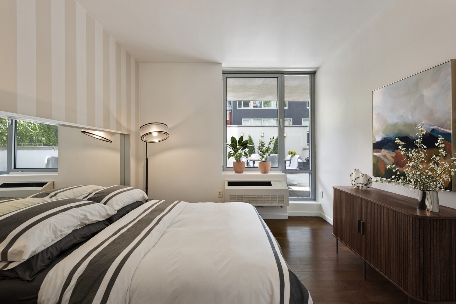 444 West 19th Street, Unit 201 Manhattan, NY 10011 - Photo 8 of 12 a bedroom with a bed and a potted plant