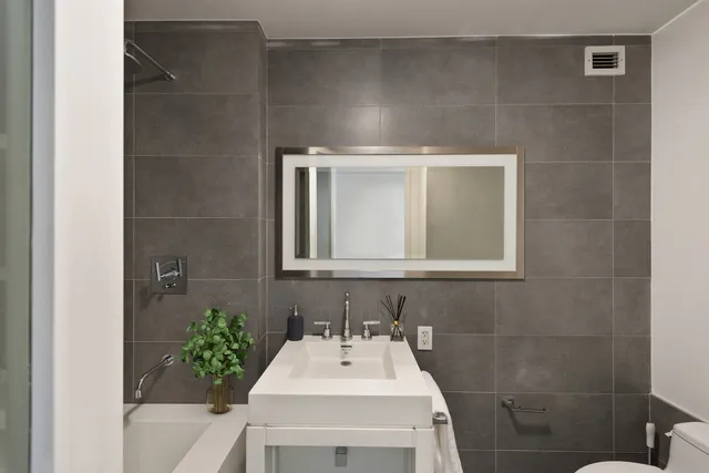 a bedroom with a bed and a potted plant