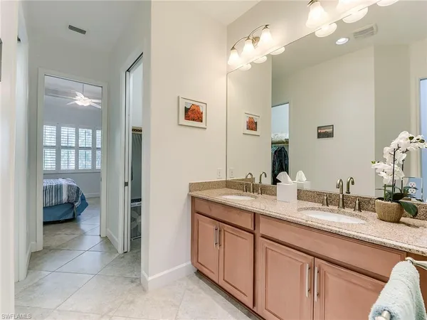 a spacious bathroom with a granite countertop sink a mirror and a