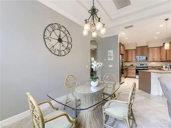 a view of a dining room with furniture a chandelier and wooden floor