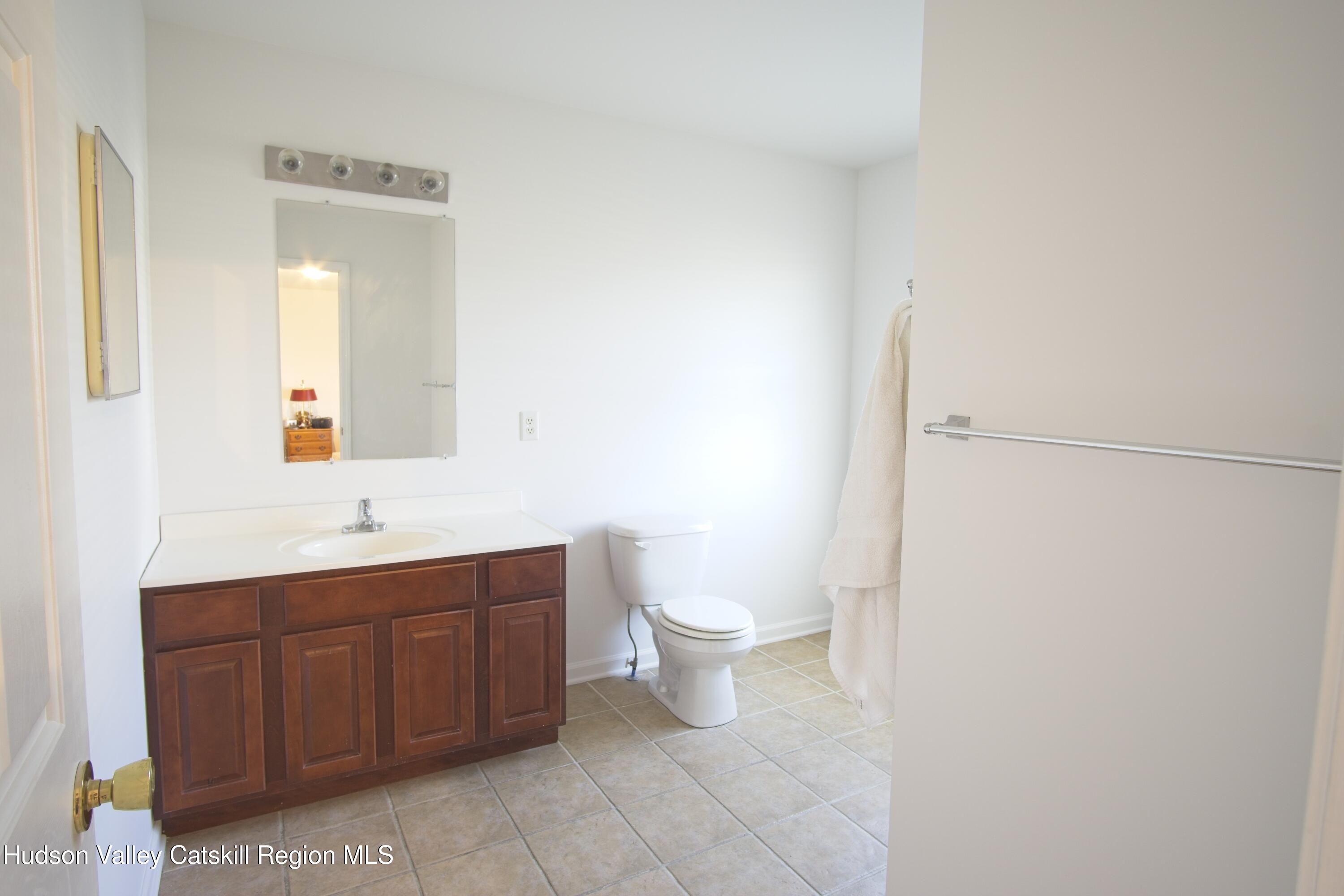 5 Van Winkle Road Hudson, NY 12534 - Photo 11 of 14 a bathroom with a toilet a sink and mirror