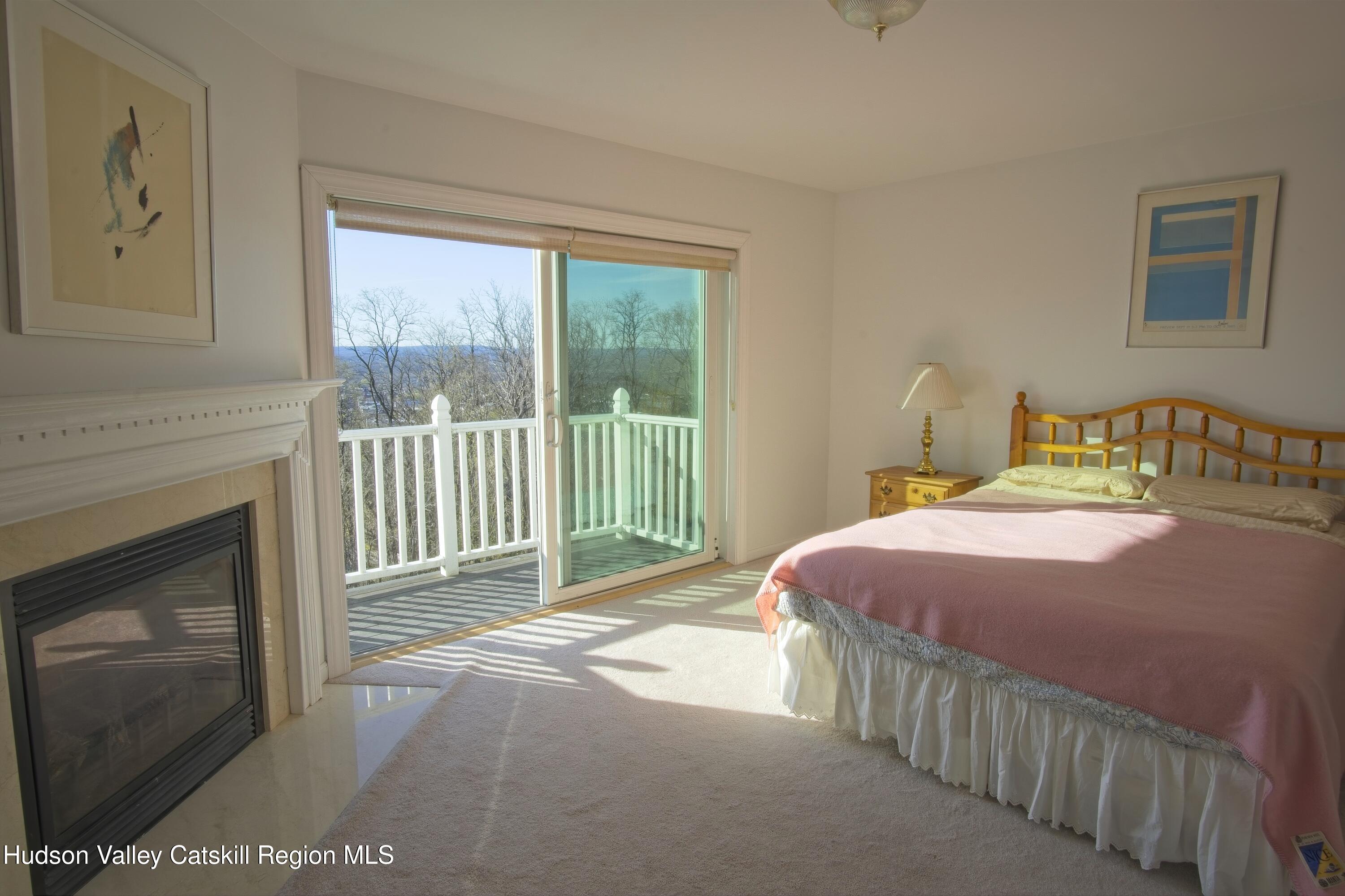 5 Van Winkle Road Hudson, NY 12534 - Photo 7 of 14 a bedroom with a bed and a fireplace