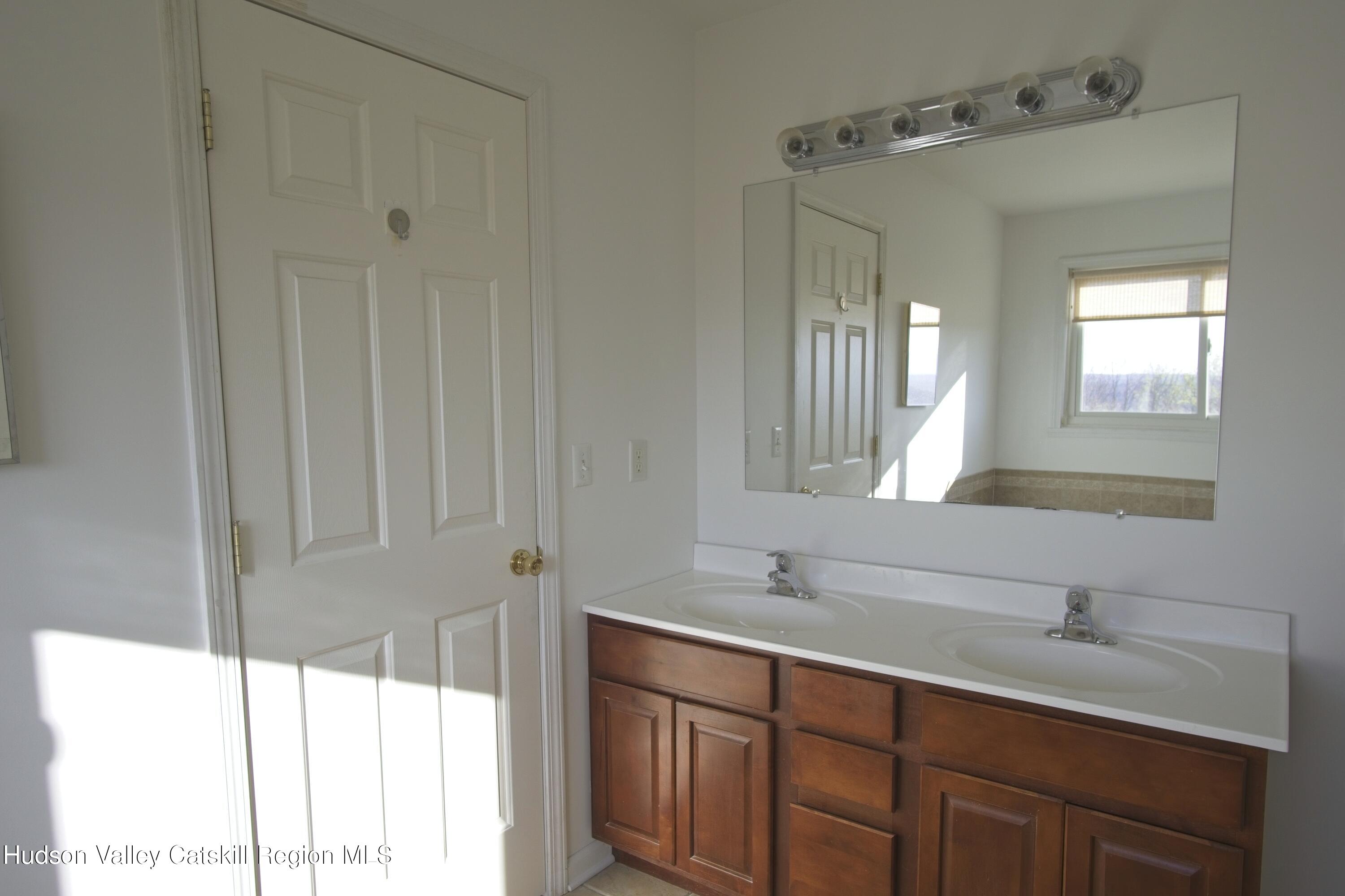 5 Van Winkle Road Hudson, NY 12534 - Photo 8 of 14 a bathroom with a double vanity sink and a mirror