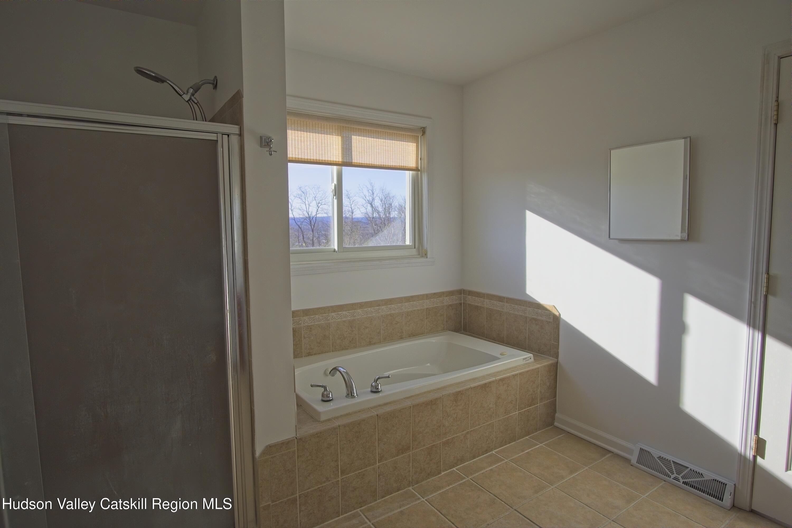 5 Van Winkle Road Hudson, NY 12534 - Photo 9 of 14 a bathroom with bathtub and window