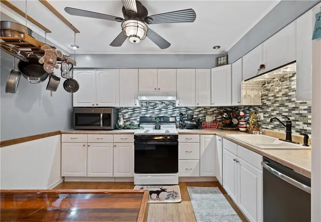 a kitchen with a sink cabinets and stainless steel appliances