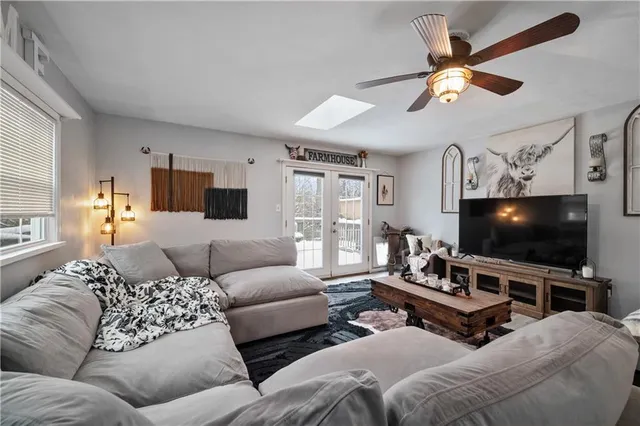 a spacious bedroom with a bed and a chandelier