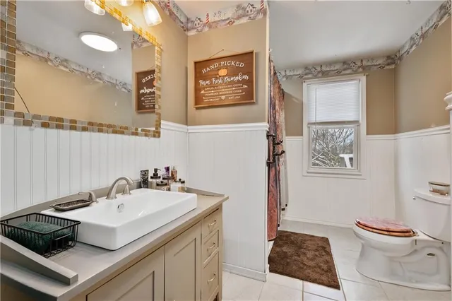 a room with wooden floors and a ceiling fan