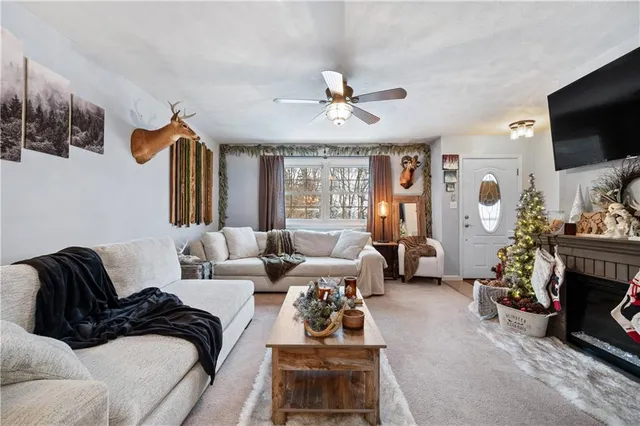 a living room with furniture a flat screen tv and a fireplace