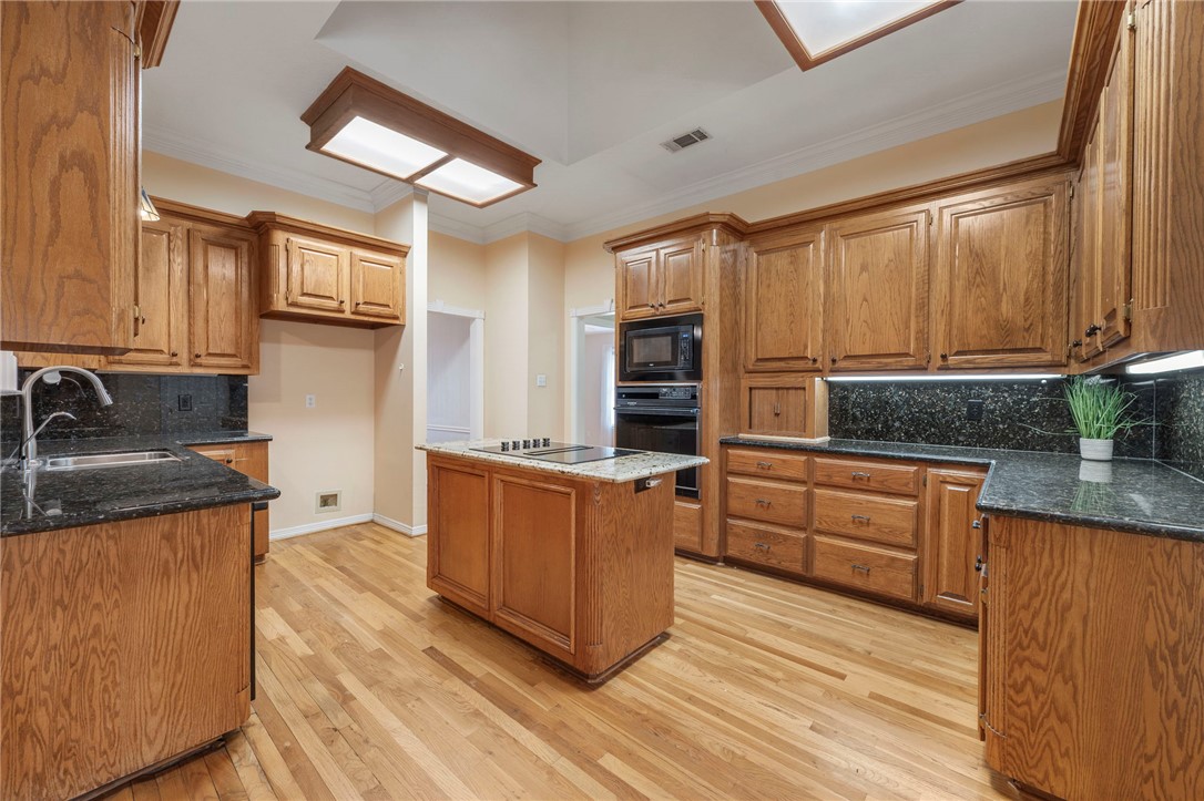 713 Willow Loop College Station, TX 77845 - Photo 10 of 39 a kitchen with stainless steel appliances granite countertop a stove a sink and a refrigerator