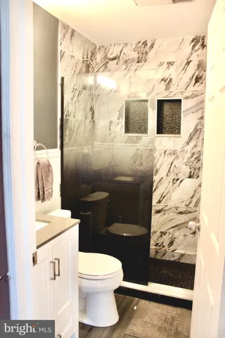 a bathroom with a toilet sink and mirror