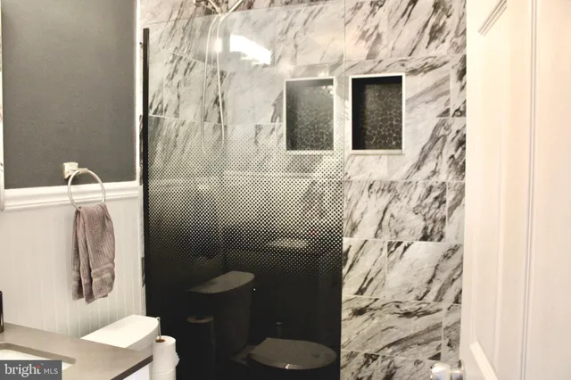 a bathroom with a toilet and a shower curtain