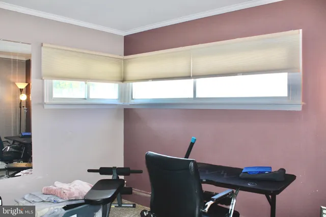 a view of a workspace with furniture and window