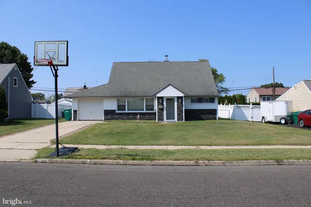 a front view of a house with a garden and yard
