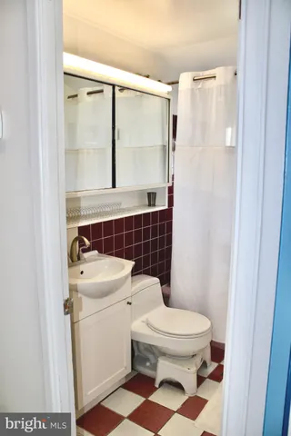 a white toilet sitting next to a bathroom sink