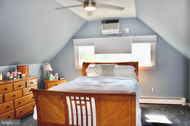 a bedroom with a bed and dresser