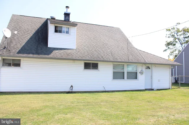 a house that has a swimming pool in front of it