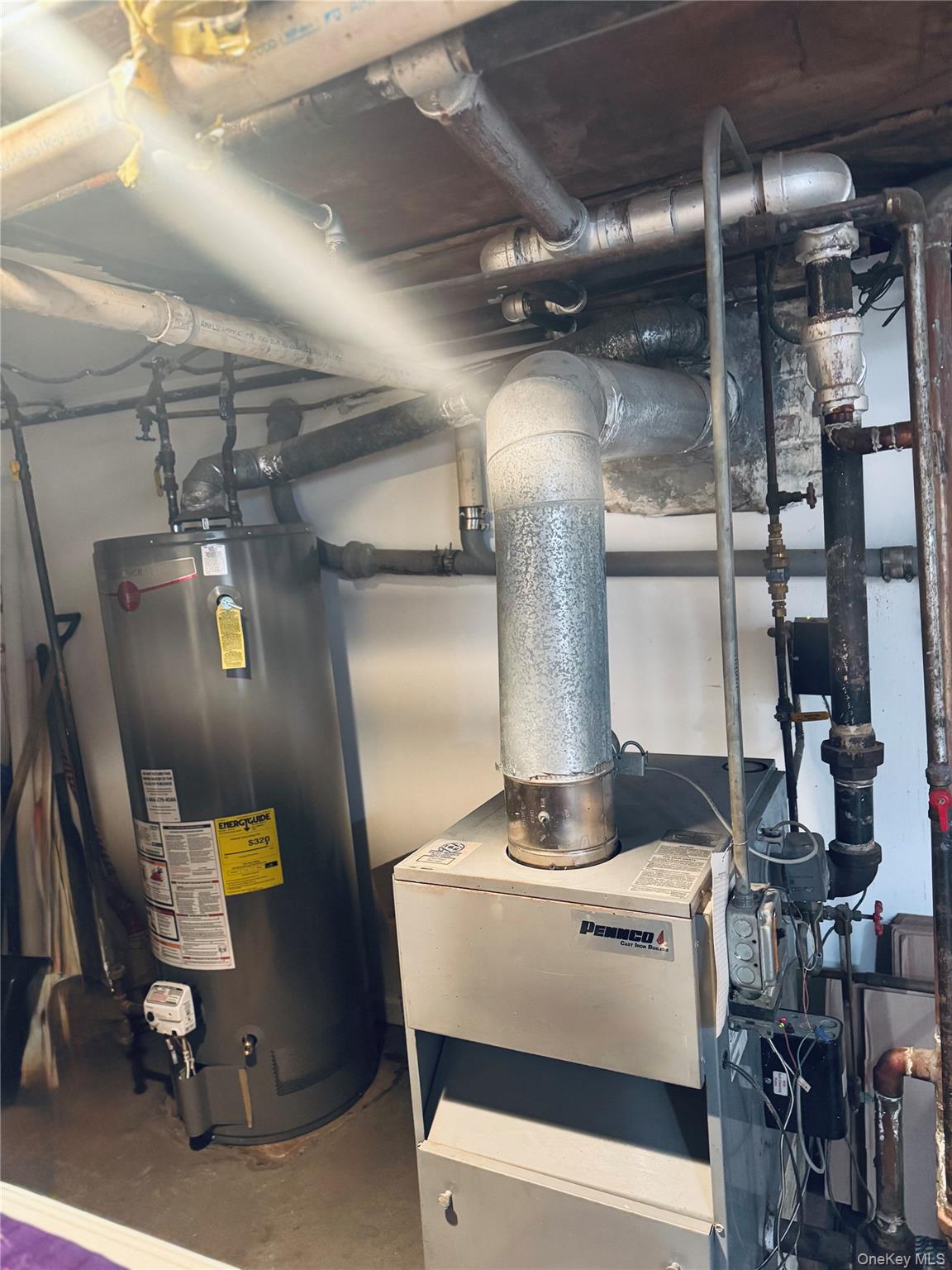 86-29 90th Street Queens, NY 11421 - Photo 6 of 14 Utility room with gas water heater and a heating unit