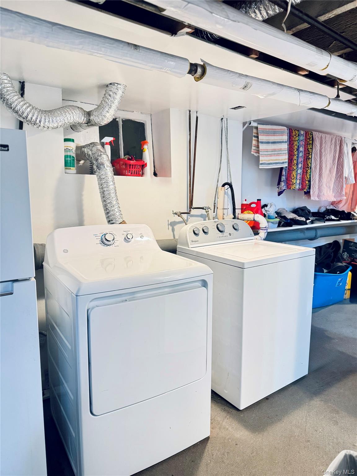 86-29 90th Street Queens, NY 11421 - Photo 7 of 14 Laundry room featuring washer and dryer and concrete floors
