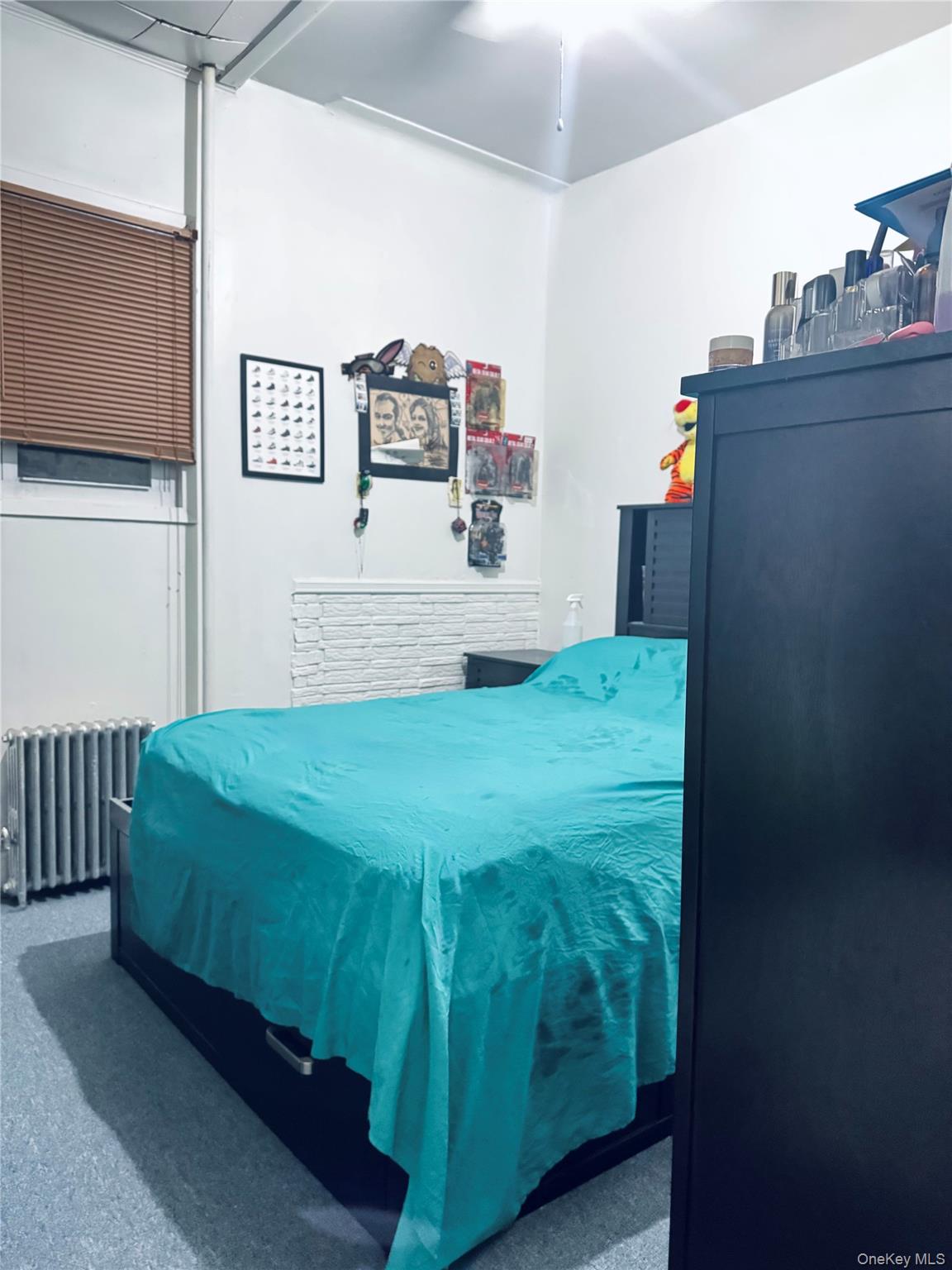 86-29 90th Street Queens, NY 11421 - Photo 10 of 14 Carpeted bedroom featuring radiator and ceiling fan