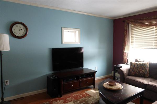 183 Beaman Road Sterling, MA 01564 - Photo 13 of 15 a living room with furniture a clock and a window