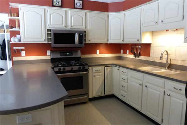 183 Beaman Road Sterling, MA 01564 - Photo 5 of 15 a kitchen with granite countertop white cabinets and stainless steel appliances