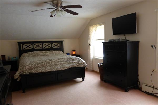 183 Beaman Road Sterling, MA 01564 - Photo 9 of 15 a bedroom with a bed and a flat tv screen