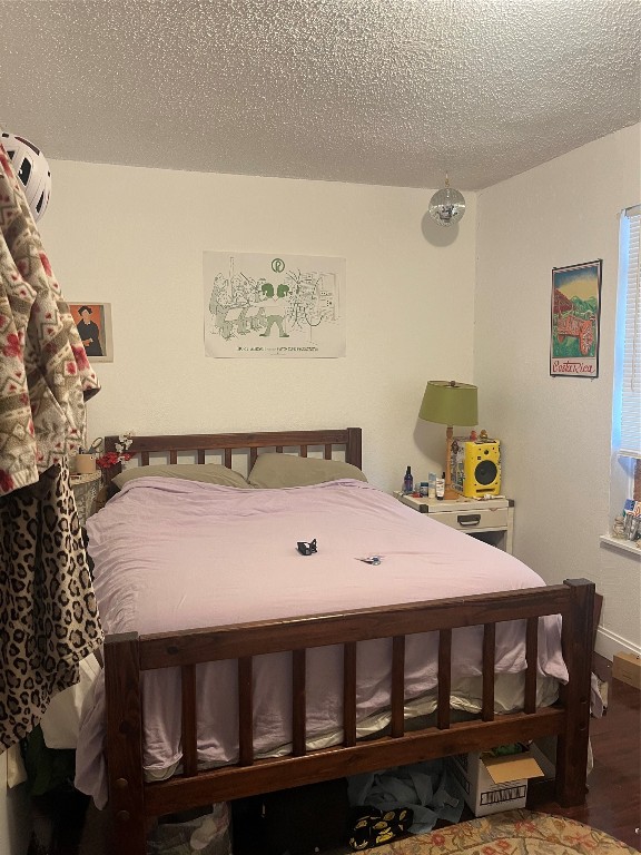 4627 Depew Avenue Austin, TX 78751 - Photo 20 of 30 a bedroom with a bed and wooden floor