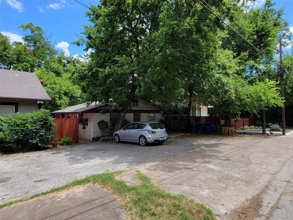 a view of a car parked in back of a house