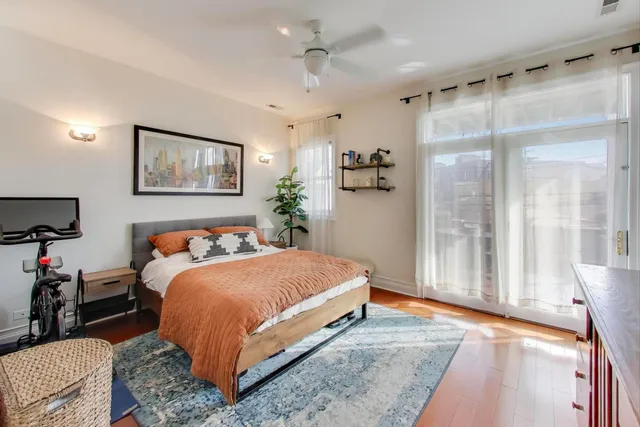 a bedroom with a large bed and a chandelier