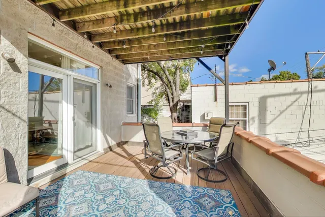 a view of a patio with table and chairs and potted plants