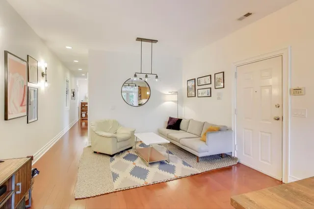 a living room with furniture and wooden floor