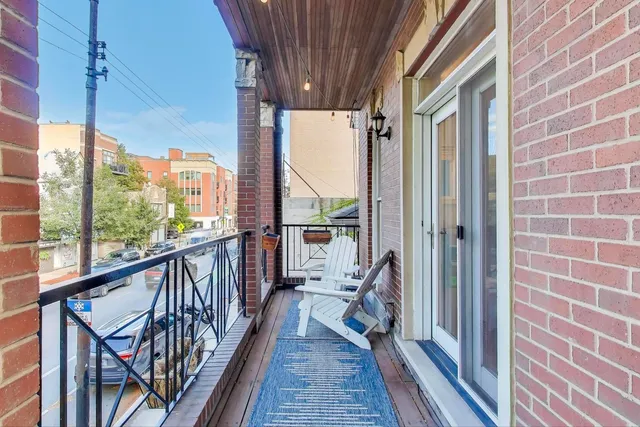 a view of a balcony with wooden floor