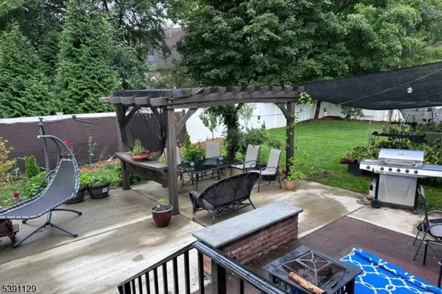 an outdoor space with seating area and trees