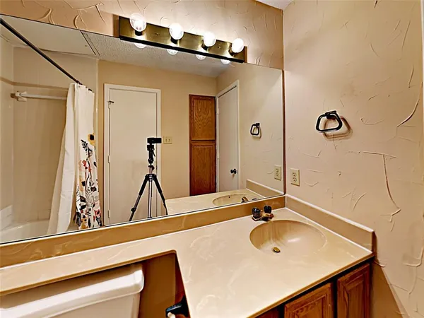 a view of a room with a ceiling fan