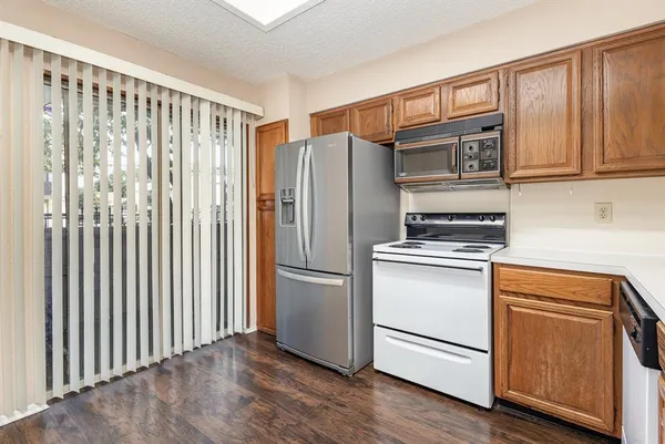a kitchen with stainless steel appliances a refrigerator sink and microwave