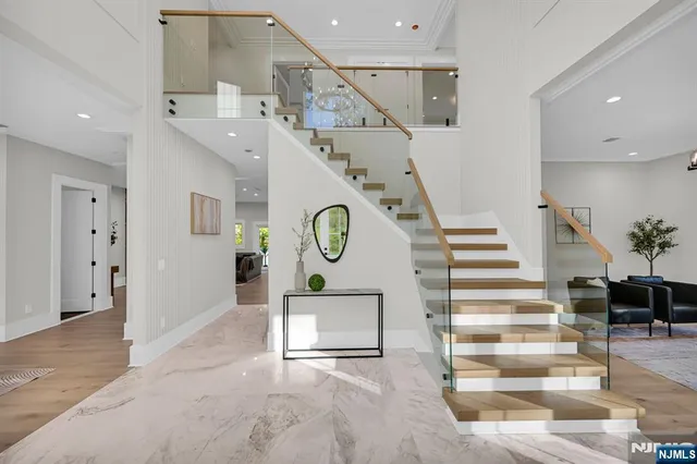 a large kitchen with stainless steel appliances kitchen island granite countertop a sink and cabinets