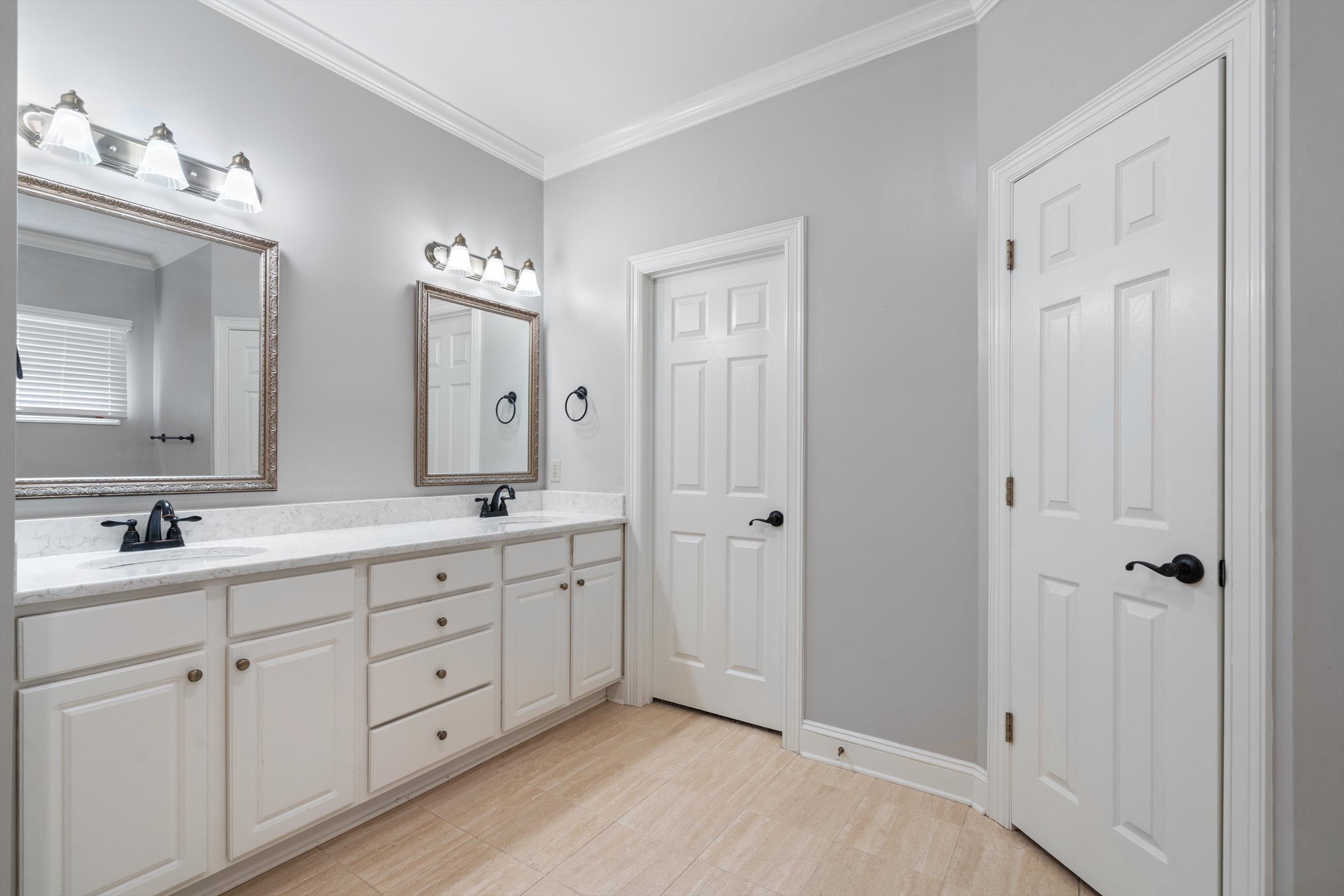 9335 Gresham Cove Germantown, TN 38139 - Photo 22 of 40 Bathroom vanity , two mirrors, and lots of light