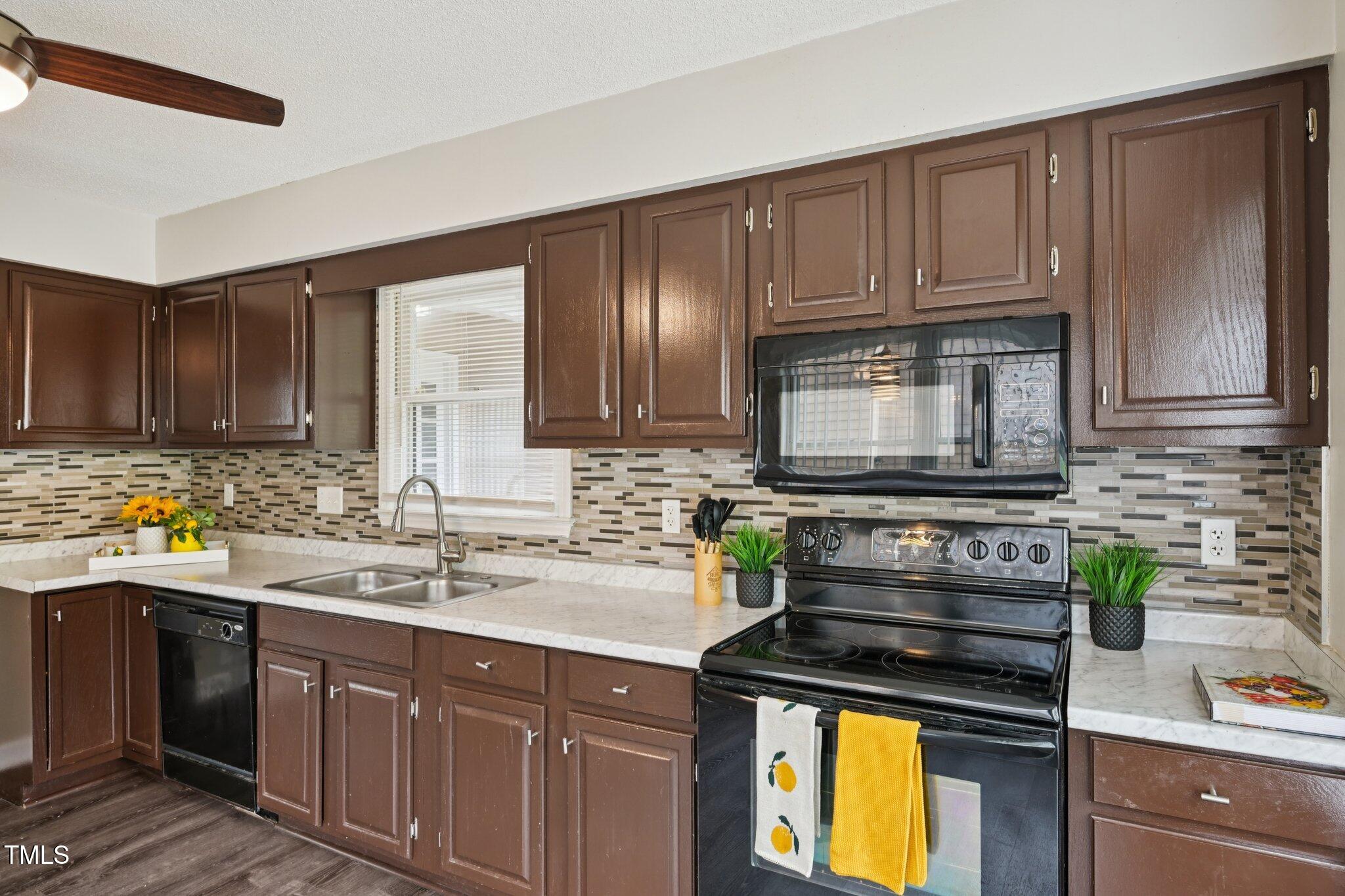 3534 Rawdon Drive Durham, NC 27713 - Photo 13 of 43 a kitchen with stainless steel appliances granite countertop a sink stove and cabinets