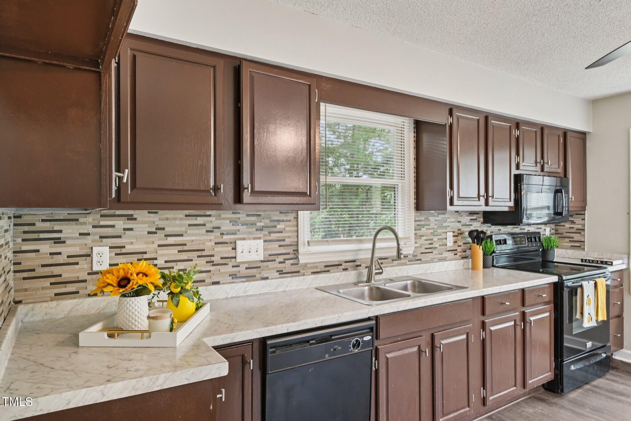 3534 Rawdon Drive Durham, NC 27713 - Photo 14 of 43 a kitchen with a sink and a cabinets