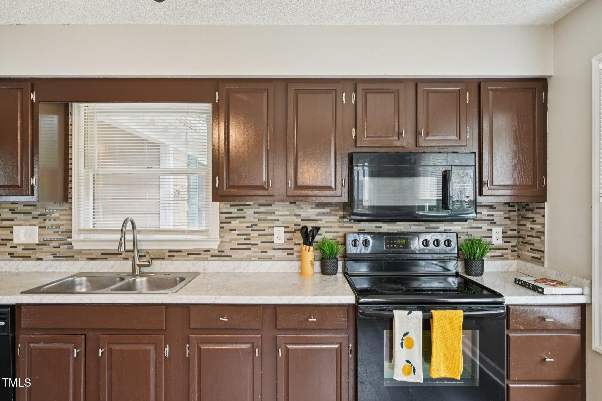 3534 Rawdon Drive Durham, NC 27713 - Photo 15 of 43 a kitchen with stainless steel appliances granite countertop a sink stove and cabinets