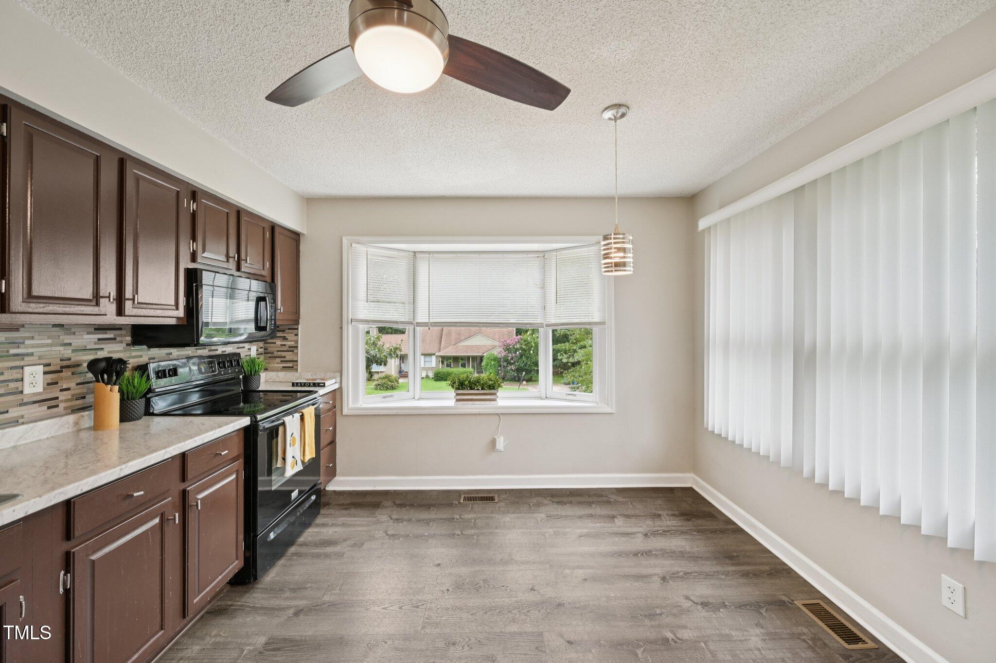 3534 Rawdon Drive Durham, NC 27713 - Photo 16 of 43 a kitchen with a window a sink and a counter top space