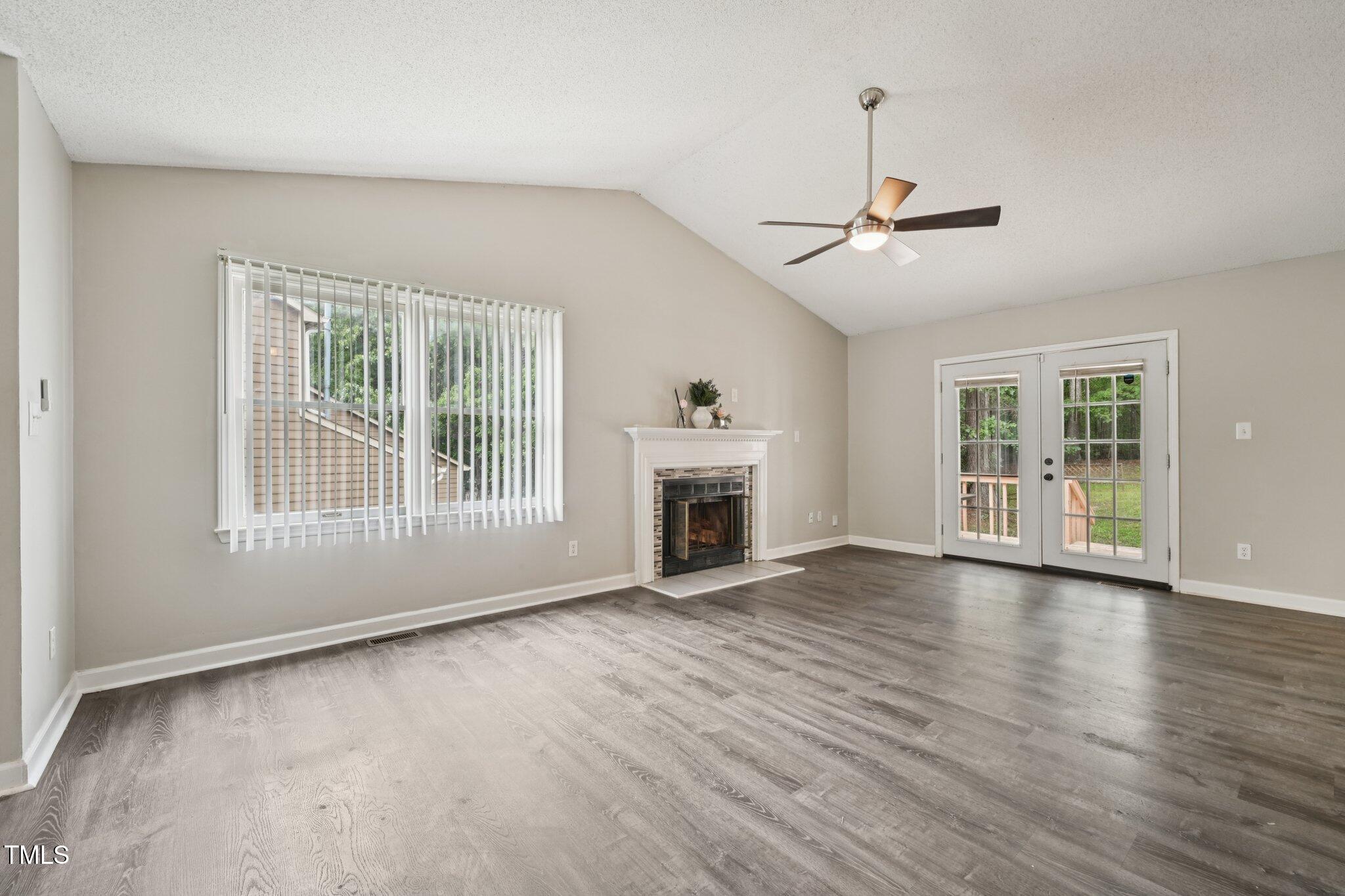 3534 Rawdon Drive Durham, NC 27713 - Photo 21 of 43 a view of an empty room with wooden floor fireplace and a window