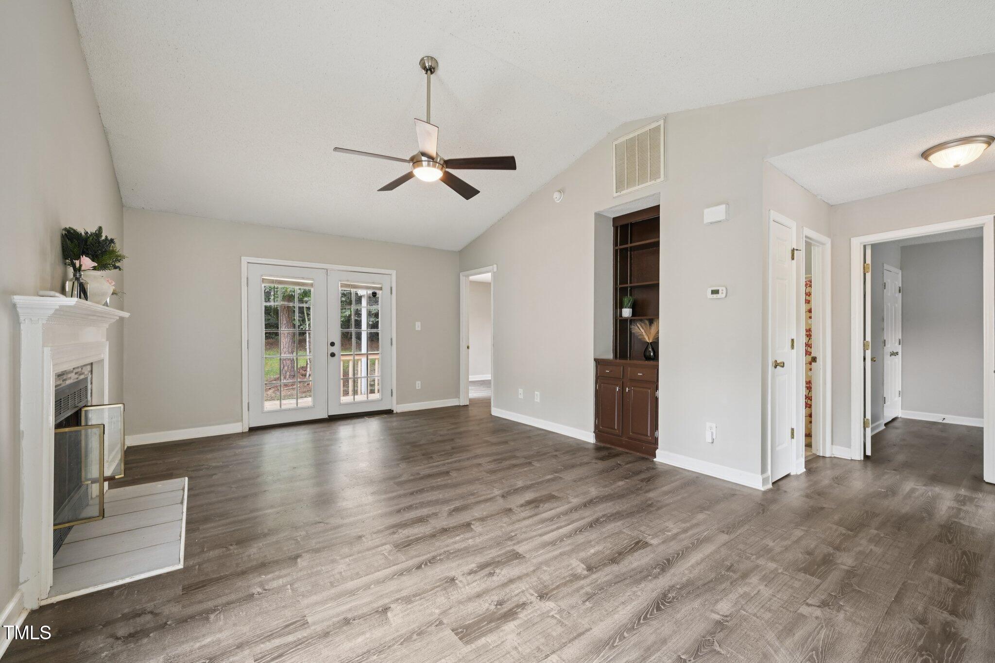 3534 Rawdon Drive Durham, NC 27713 - Photo 24 of 43 a view of empty room with wooden floor and fireplace